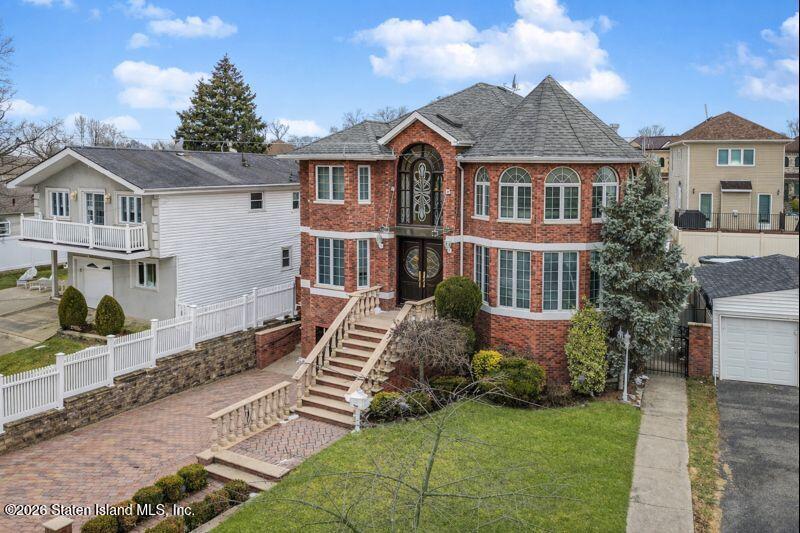5125 Amboy Road Staten Island, NY 10312 - Photo 5 of 33 a front view of a house with a garden and plants