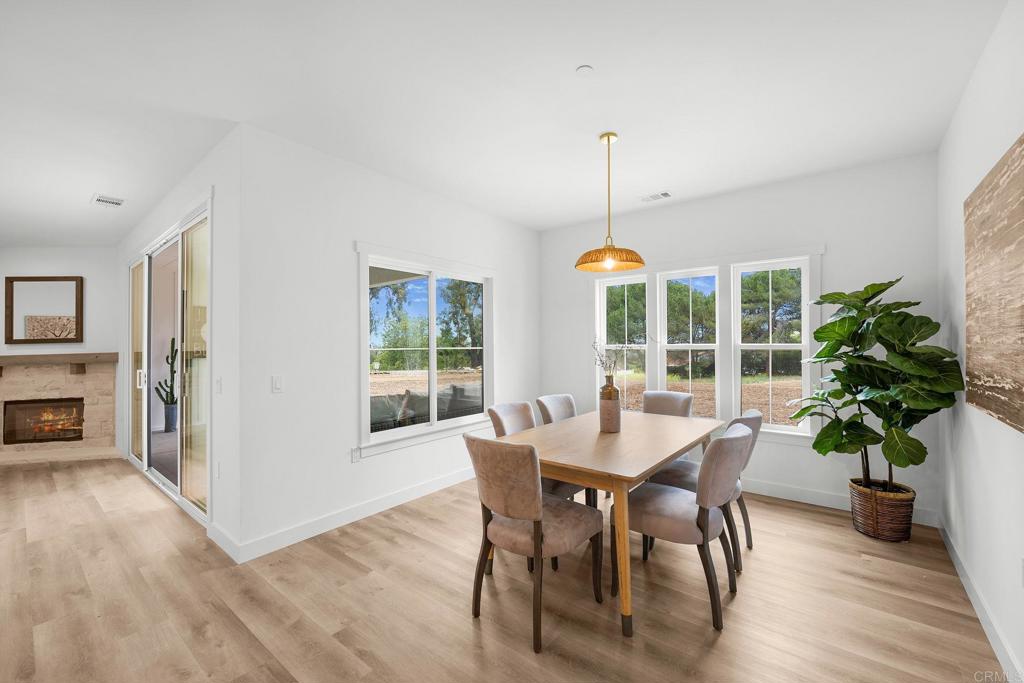 1547 Dickey Street Fallbrook, CA 92028 - Photo 17 of 45 a dining room with furniture potted plants and wooden floor