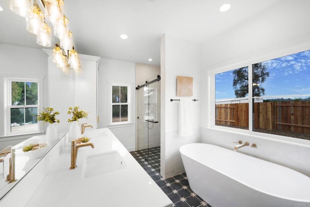 1547 Dickey Street Fallbrook, CA 92028 - Photo 24 of 45 a bathroom with a tub a potted plant and a large window