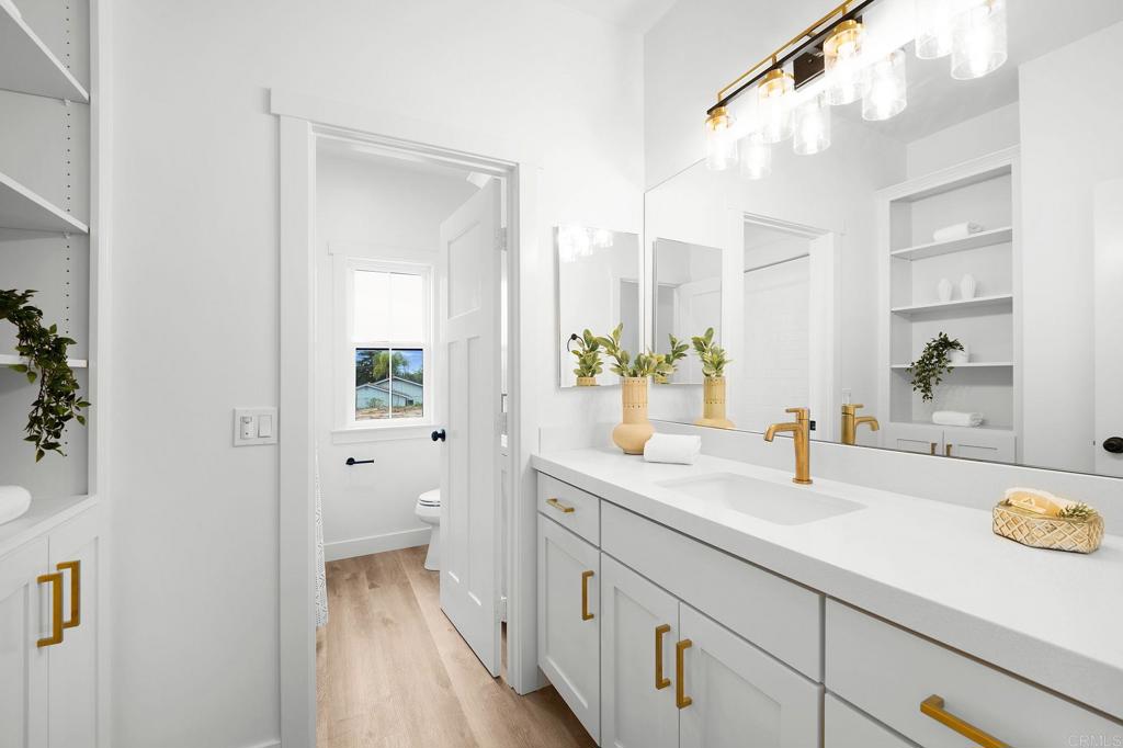 1547 Dickey Street Fallbrook, CA 92028 - Photo 35 of 45 a bathroom with a sink a mirror and a toilet