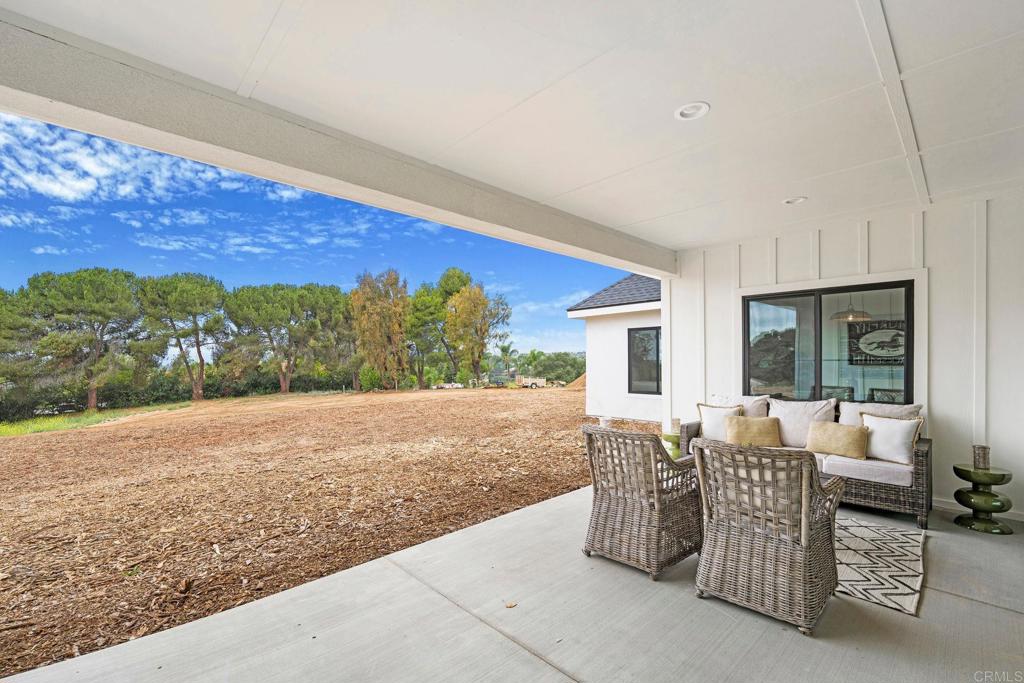 1547 Dickey Street Fallbrook, CA 92028 - Photo 40 of 45 a view of a patio with couches and table and chairs and potted plants