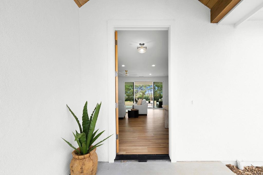 1547 Dickey Street Fallbrook, CA 92028 - Photo 45 of 45 a hallway with a couch and a potted plant