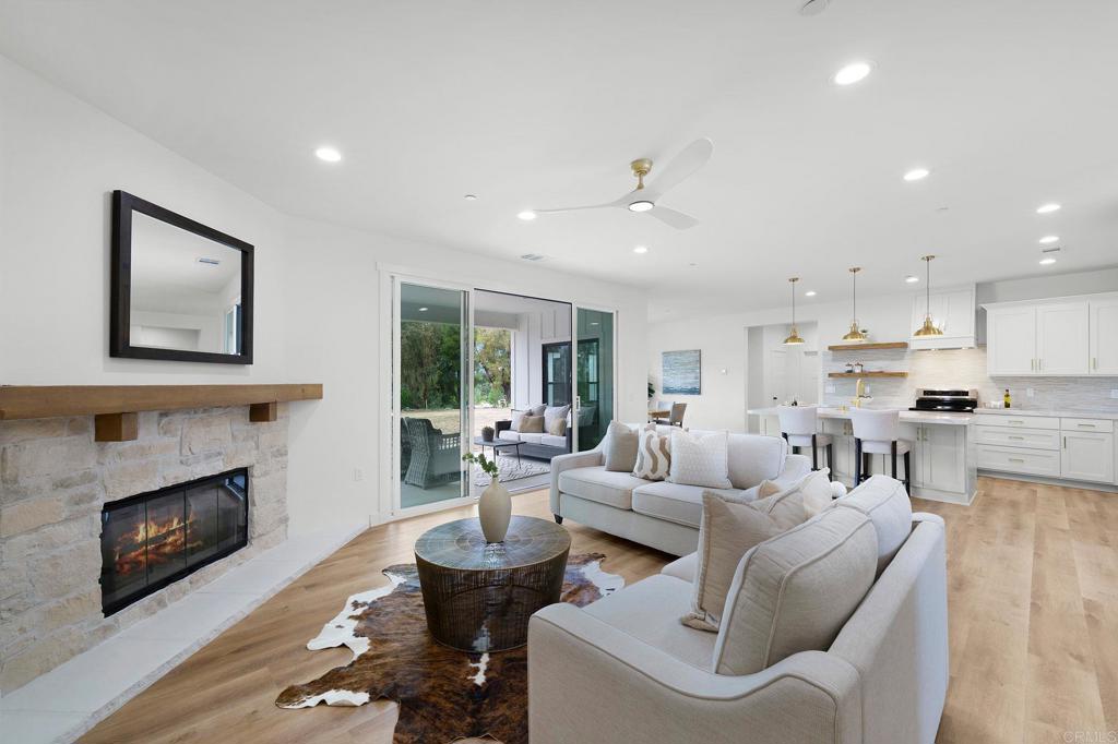 1547 Dickey Street Fallbrook, CA 92028 - Photo 6 of 45 a living room with furniture fireplace and kitchen view
