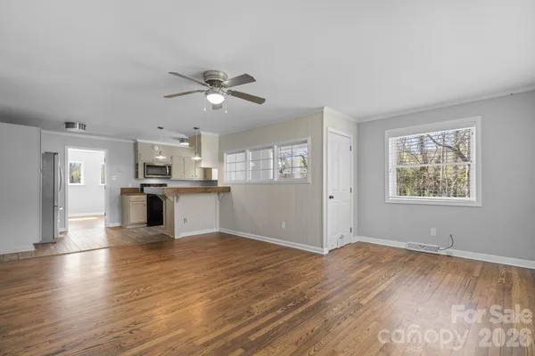 a view of a kitchen with wooden floor and a kitchen