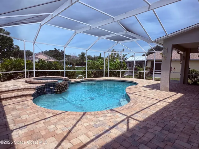 a view of a swimming pool with a patio