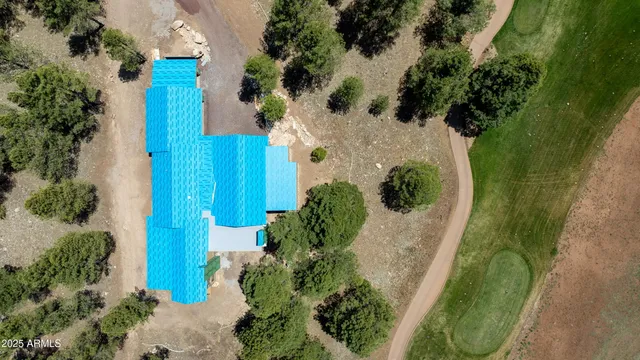 an aerial view of a house with a yard