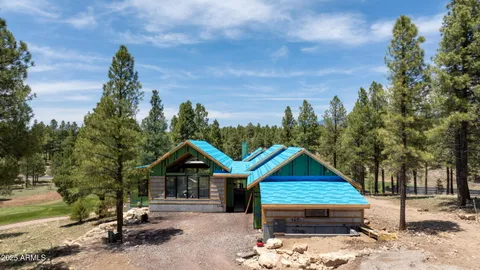a view of a house with a yard siting area and garden
