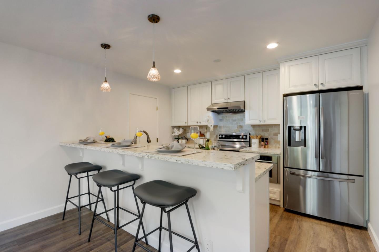 1653 Albatross Drive Sunnyvale, CA 94087 - Photo 14 of 44 a kitchen with stainless steel appliances a refrigerator and a stove top oven
