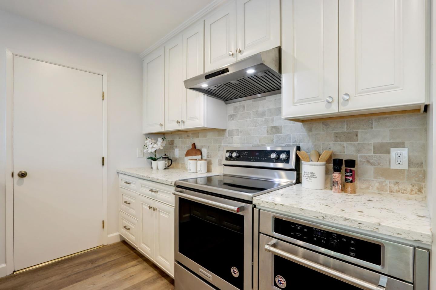 1653 Albatross Drive Sunnyvale, CA 94087 - Photo 16 of 44 a kitchen with stainless steel appliances white cabinets and a stove a sink