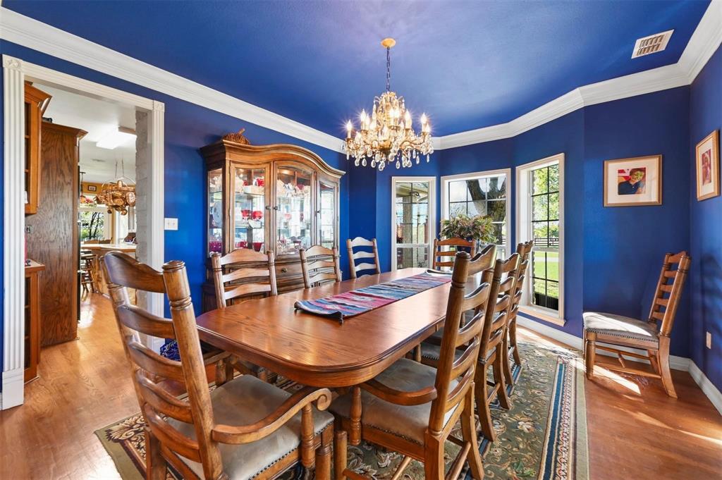 1990 Ripy Road Krum, TX 76249 - Photo 11 of 40 a view of a dining room with furniture a chandelier and wooden floor