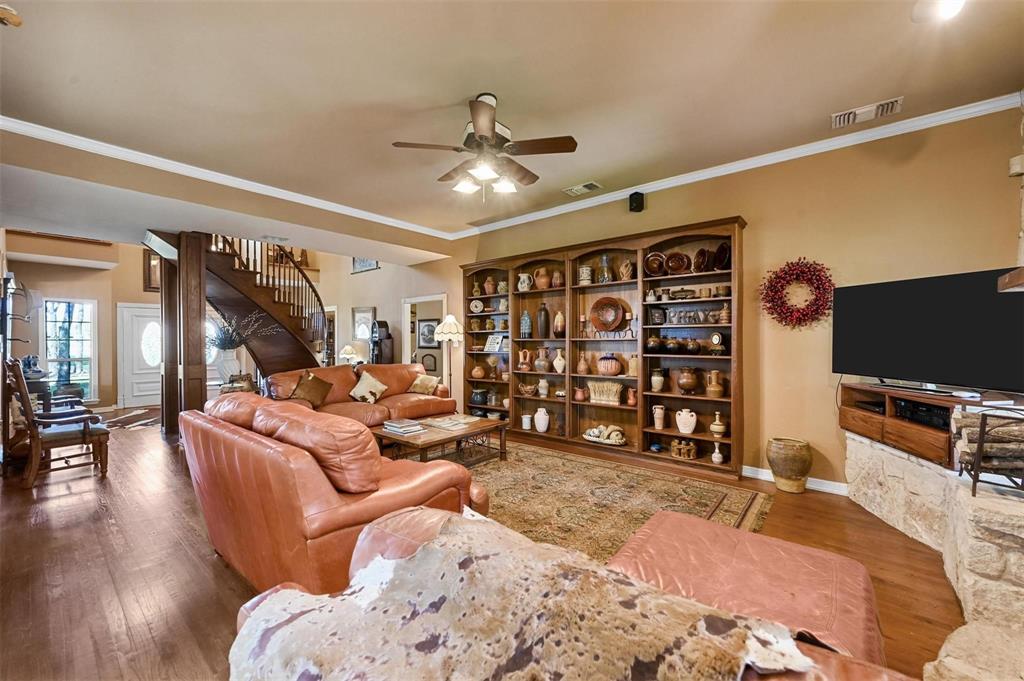 1990 Ripy Road Krum, TX 76249 - Photo 13 of 40 a living room with furniture a ceiling fan and a wooden floor