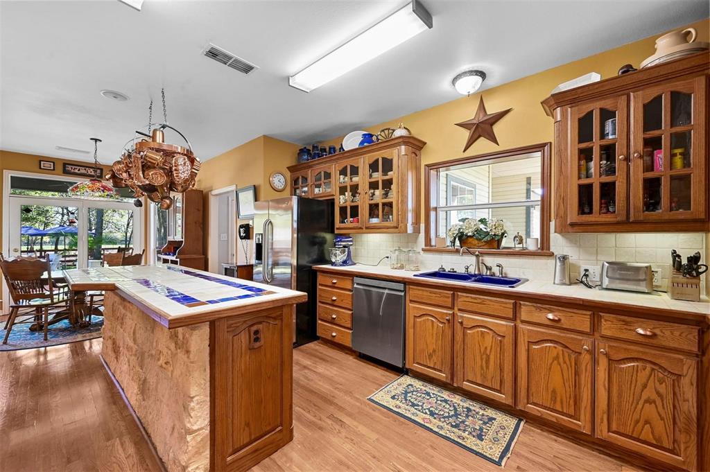 1990 Ripy Road Krum, TX 76249 - Photo 14 of 40 a kitchen that has a lot of cabinets in it