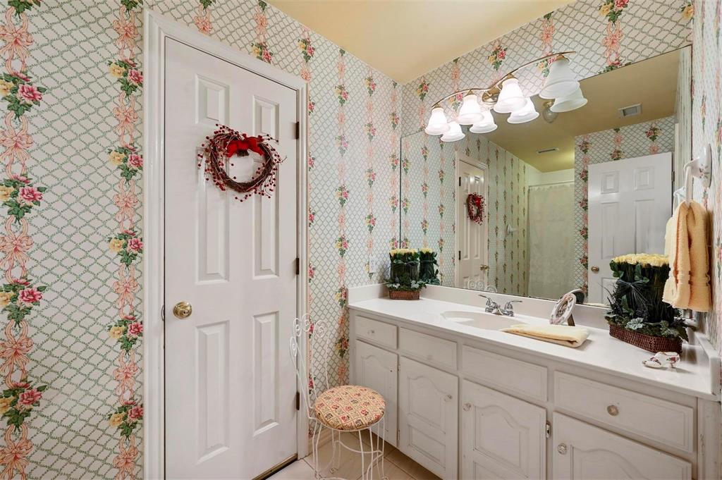 1990 Ripy Road Krum, TX 76249 - Photo 25 of 40 a bathroom with a sink and a mirror