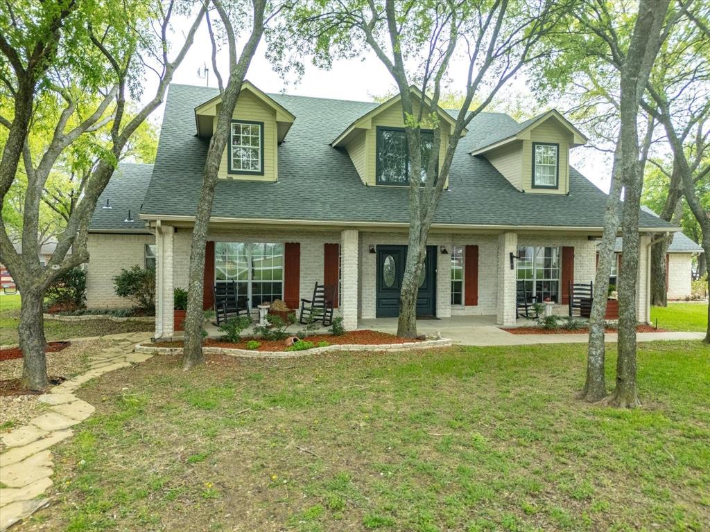 1990 Ripy Road Krum, TX 76249 - Photo 6 of 40 front view of a brick house with a yard
