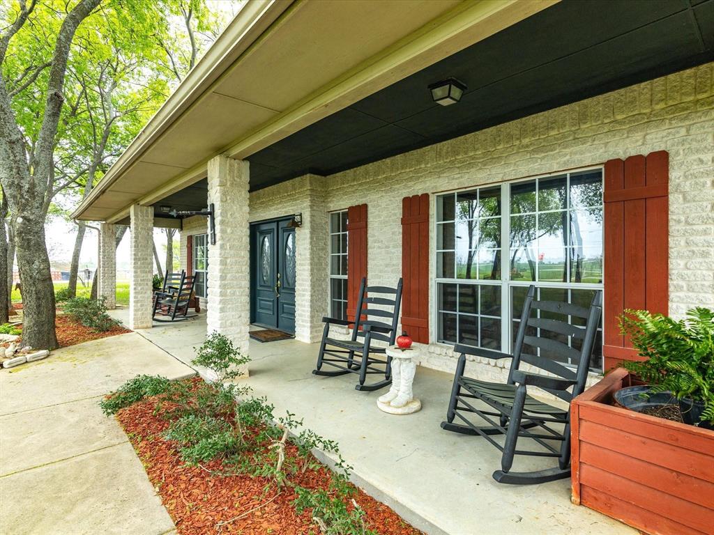 1990 Ripy Road Krum, TX 76249 - Photo 7 of 40 a building outdoor space with patio furniture and garden