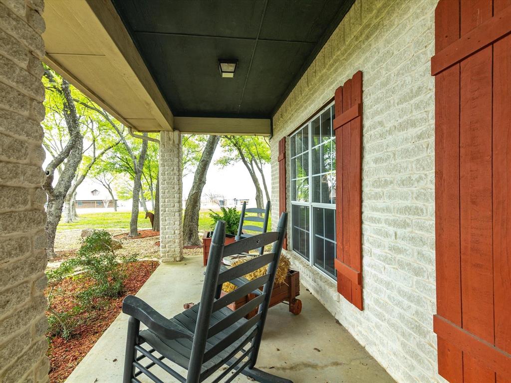 1990 Ripy Road Krum, TX 76249 - Photo 8 of 40 a living room with large windows and outdoor seating