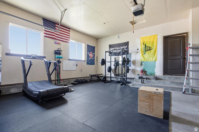 1634 West Arimo Road Arimo, ID 83214 - Photo 22 of 89 Garage space featuring rubber flooring, multiple windows, an interior access door, and painted walls