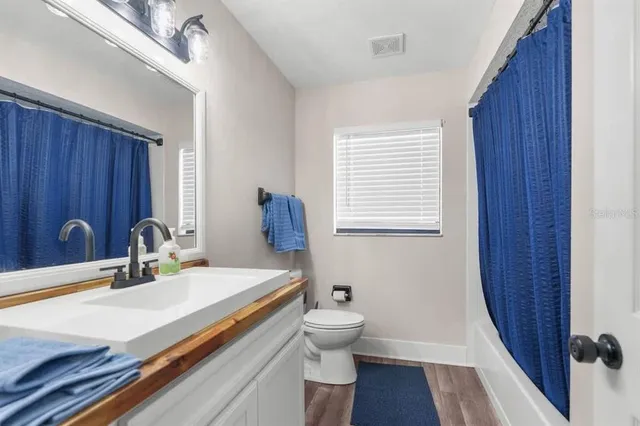 a bathroom with a sink and a large mirror