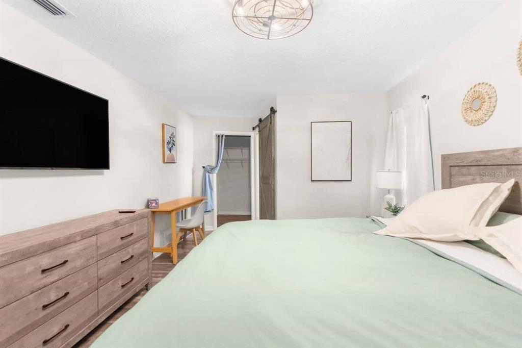 13501 Whitby Road Hudson, FL 34667 - Photo 12 of 25 a bedroom with a bed and a flat screen tv