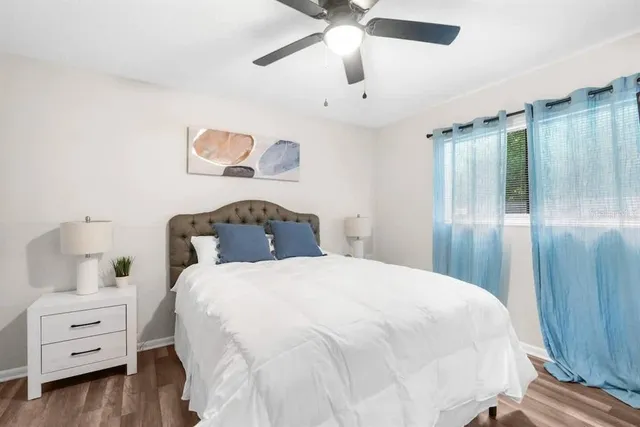 a bedroom with a bed and a chandelier