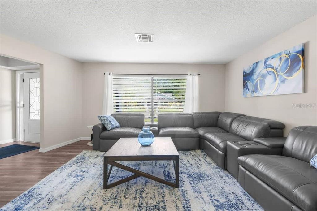 13501 Whitby Road Hudson, FL 34667 - Photo 22 of 25 a living room with furniture wooden floor and a large window