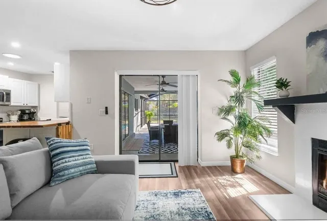 a living room with furniture and a potted plant