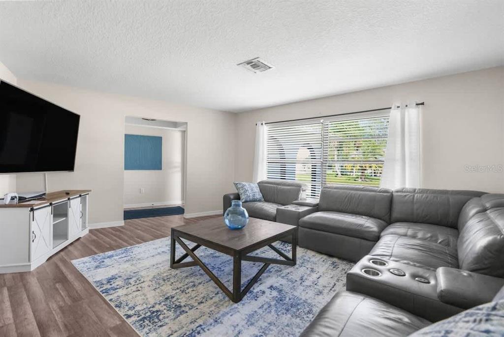 13501 Whitby Road Hudson, FL 34667 - Photo 4 of 25 a living room with furniture and a flat screen tv