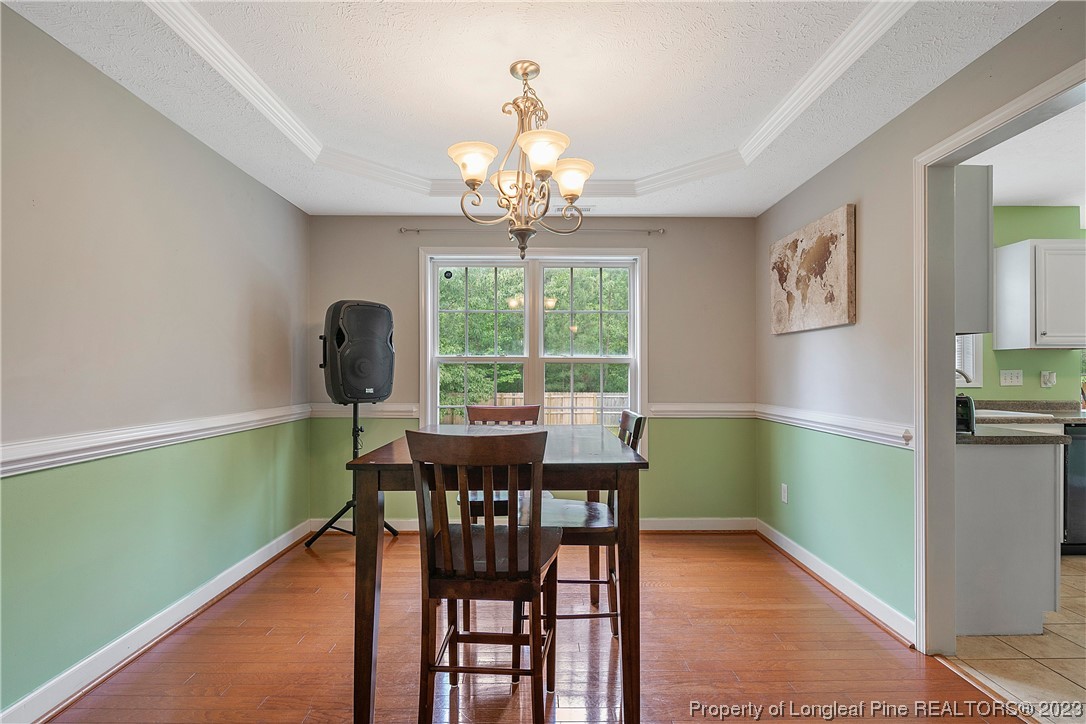 250 Pender Road Spring Lake, NC 28390 - Photo 11 of 50 a view of a dining room with furniture a chandelier and window