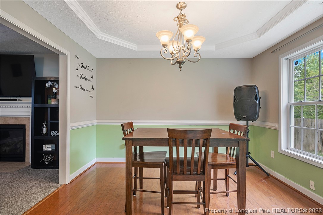 250 Pender Road Spring Lake, NC 28390 - Photo 13 of 50 a view of a dining room with furniture a chandelier and window