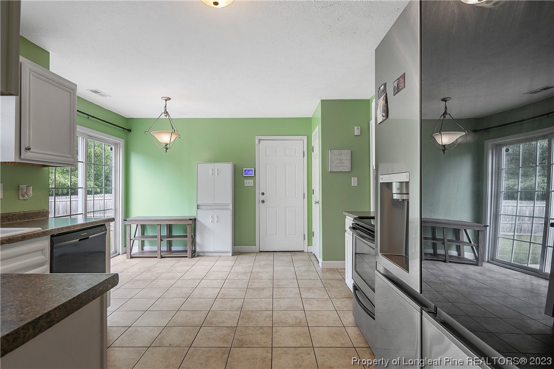250 Pender Road Spring Lake, NC 28390 - Photo 14 of 50 a large kitchen with stainless steel appliances a refrigerator and a stove top oven