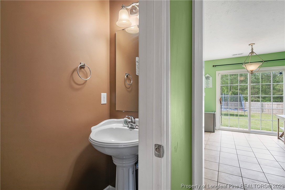 250 Pender Road Spring Lake, NC 28390 - Photo 22 of 50 a bathroom with a sink a toilet and shower