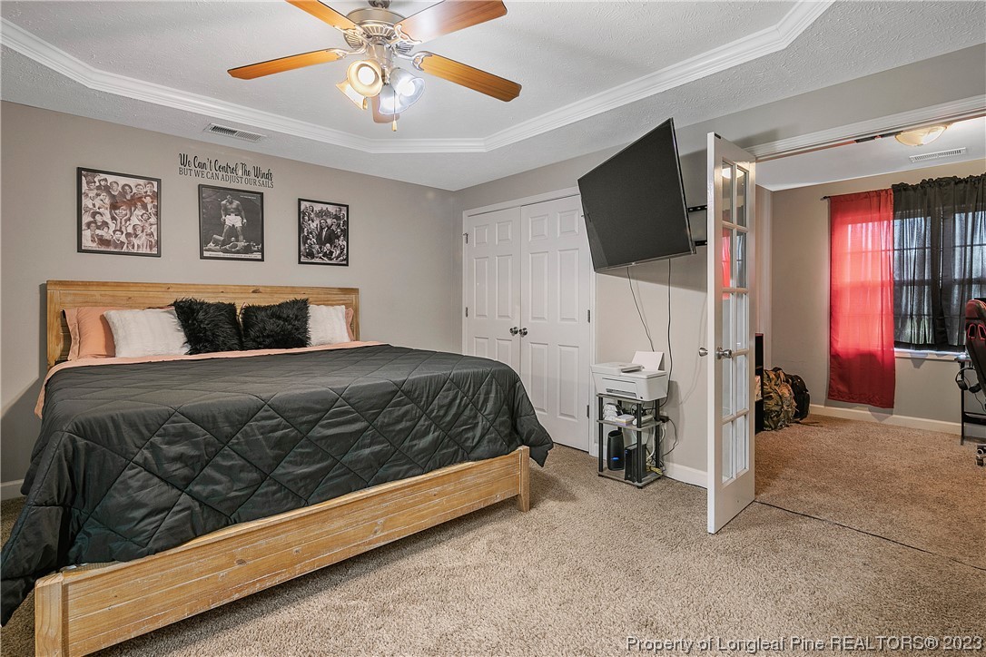 250 Pender Road Spring Lake, NC 28390 - Photo 24 of 50 a bedroom with a bed and a flat screen tv