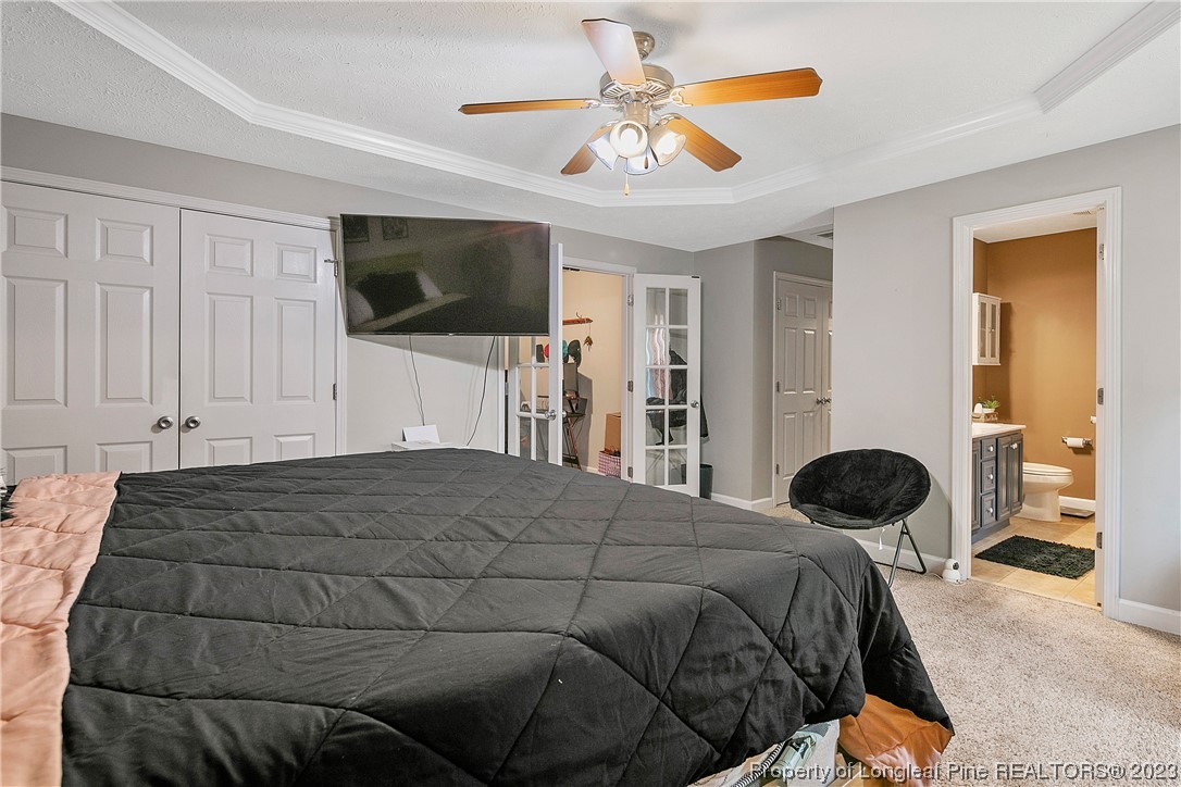 250 Pender Road Spring Lake, NC 28390 - Photo 25 of 50 a bedroom with a bed and a flat screen tv
