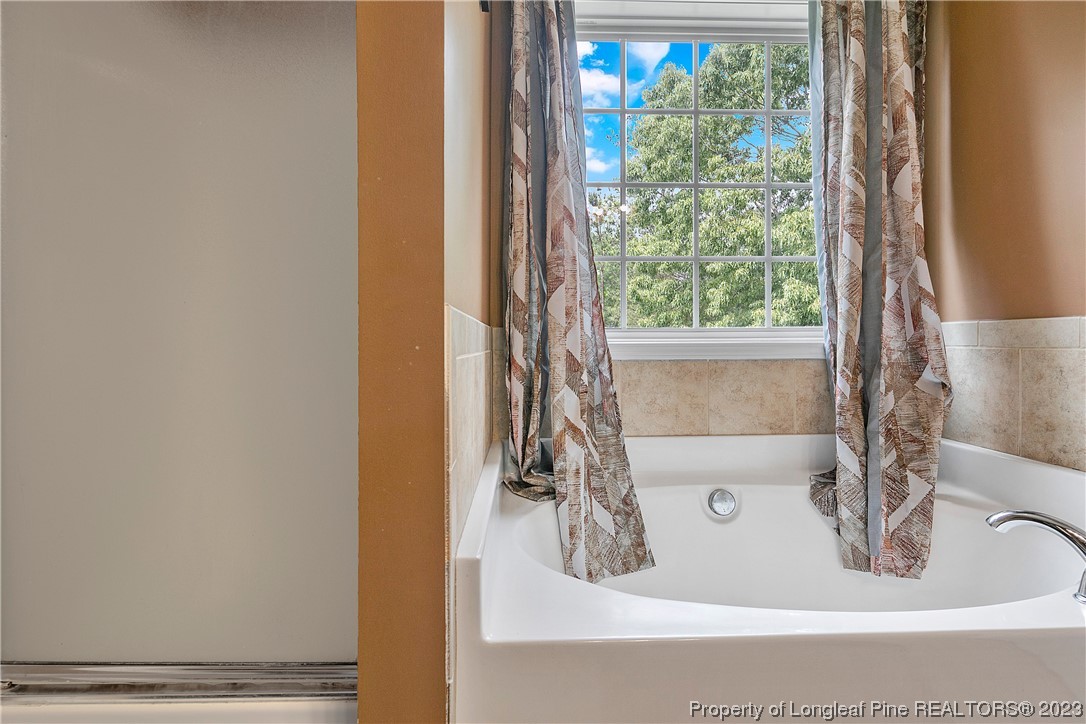 250 Pender Road Spring Lake, NC 28390 - Photo 30 of 50 a bath tub sitting in a bathroom next to a window