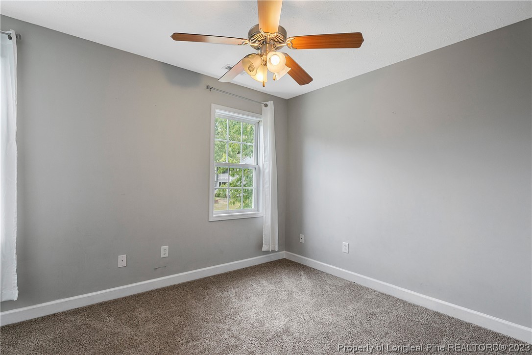 250 Pender Road Spring Lake, NC 28390 - Photo 32 of 50 an empty room with a window and a chandelier fan