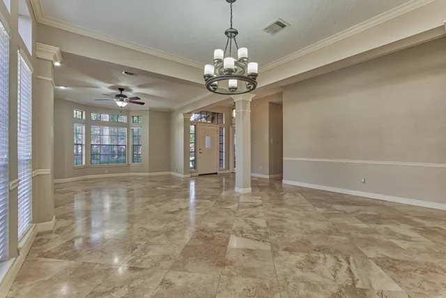 a view of an empty room with a chandelier