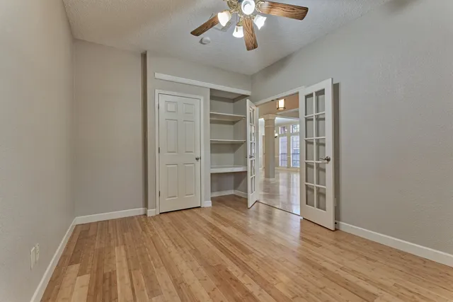 a large kitchen with granite countertop a large counter top appliances and cabinets