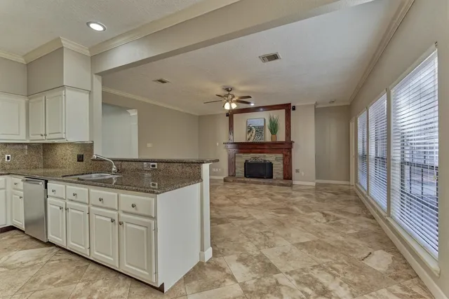 a view of empty room with fireplace and fan