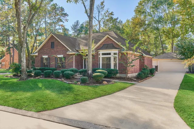 a front view of a house with a yard and potted plants