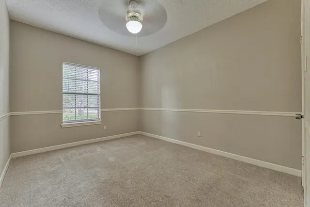 a bathroom with a granite countertop sink a mirror and a bathtub