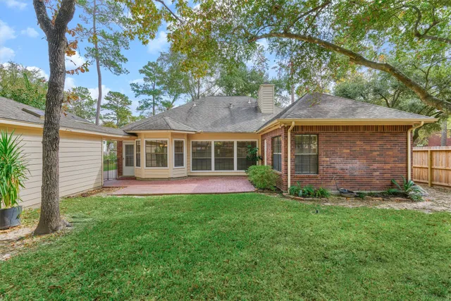 a view of a brick house with plants and wooden floor