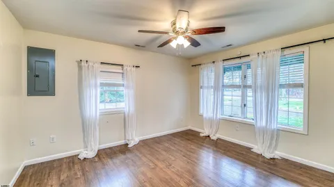 wooden floor in an empty room with a window