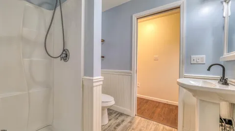 a bathroom with a granite countertop sink toilet and shower