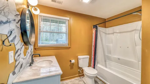 a bathroom with a sink toilet and shower