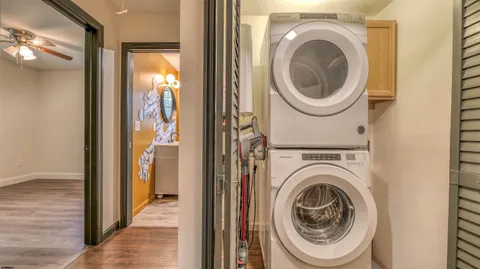 a view of a hallway with washer and dryer