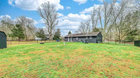 a view of a house with yard and tree s