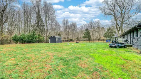 a view of yard with swimming pool and trees