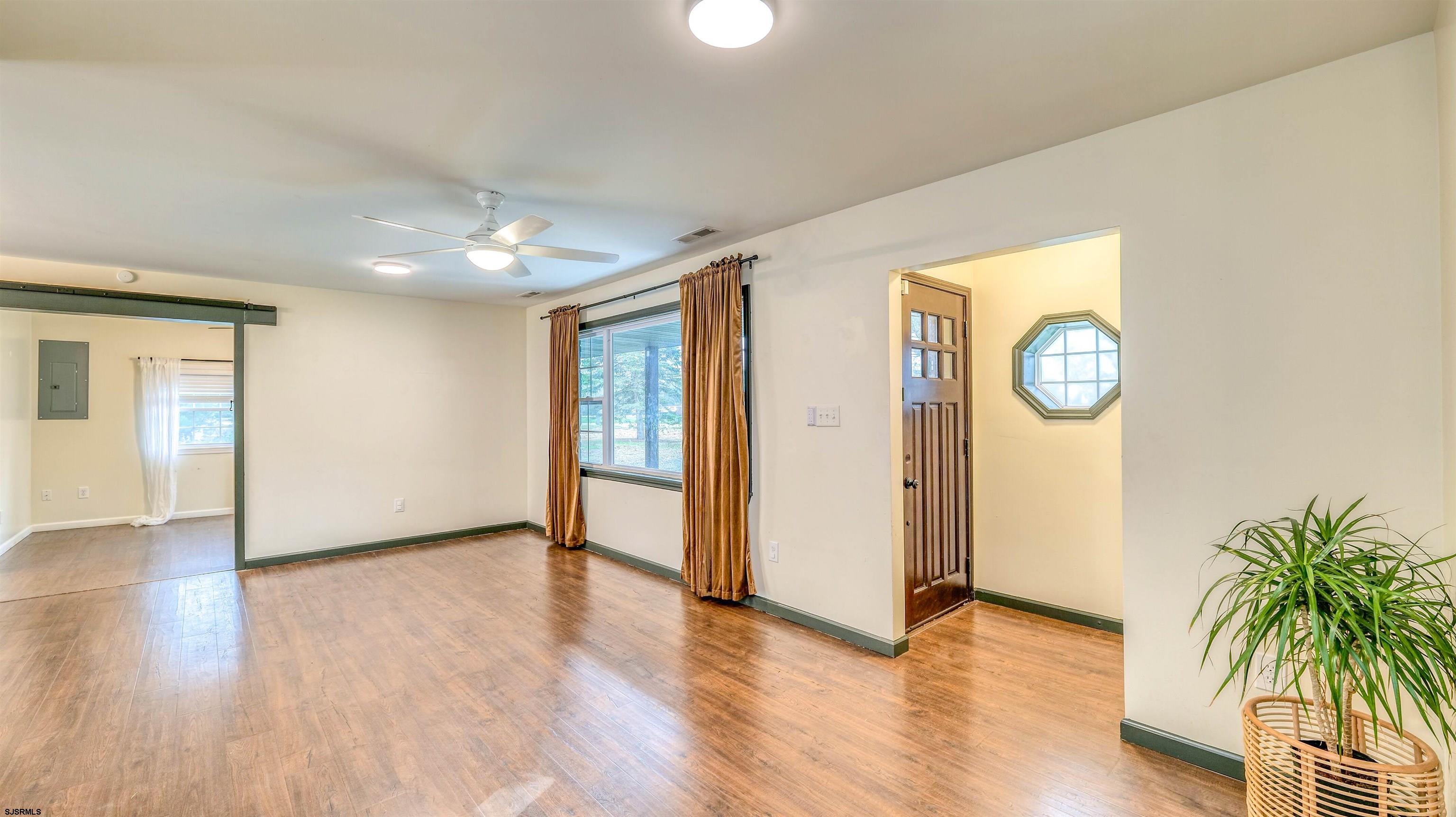 1048 Ocean Heights Avenue Egg Harbor Township, NJ 08234 - Photo 6 of 30 a view of an empty room with wooden floor and a window