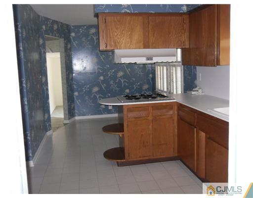 9 Bodnarik Road Edison, NJ 08837 - Photo 3 of 8 a kitchen with a sink and a refrigerator