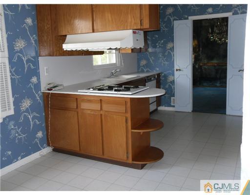 9 Bodnarik Road Edison, NJ 08837 - Photo 7 of 8 a stove top oven sitting inside of a kitchen